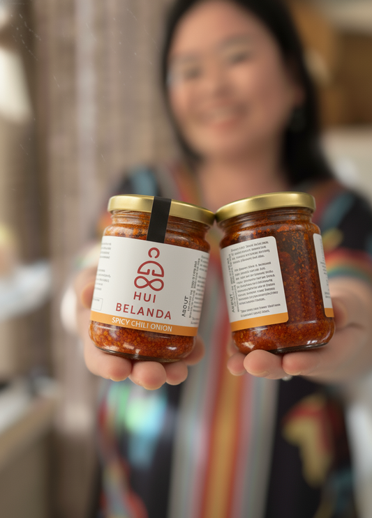 Person holding two jars of 'Hui Belanda' Spicy Chili Onion - Sambal Bawang
